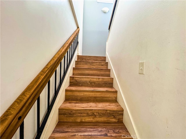 stairway featuring hardwood / wood-style flooring