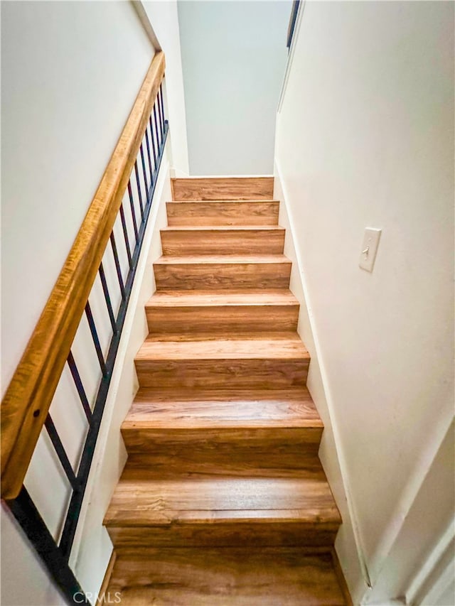 staircase featuring hardwood / wood-style flooring