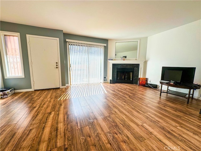 unfurnished living room featuring hardwood / wood-style flooring and a fireplace