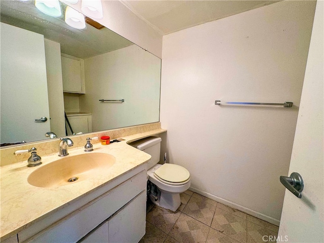 bathroom with vanity, toilet, and tile patterned floors