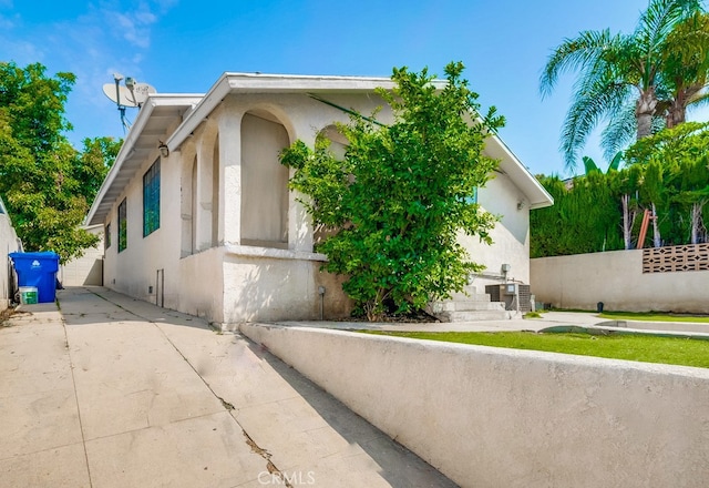 view of property exterior featuring a patio and central air condition unit