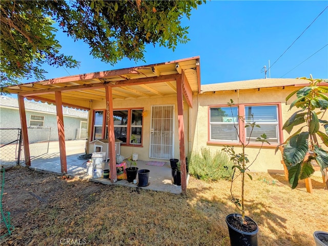 rear view of property featuring a patio area