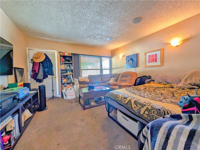 bedroom with carpet flooring and a textured ceiling