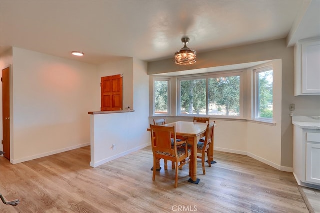 dining space featuring light wood-type flooring