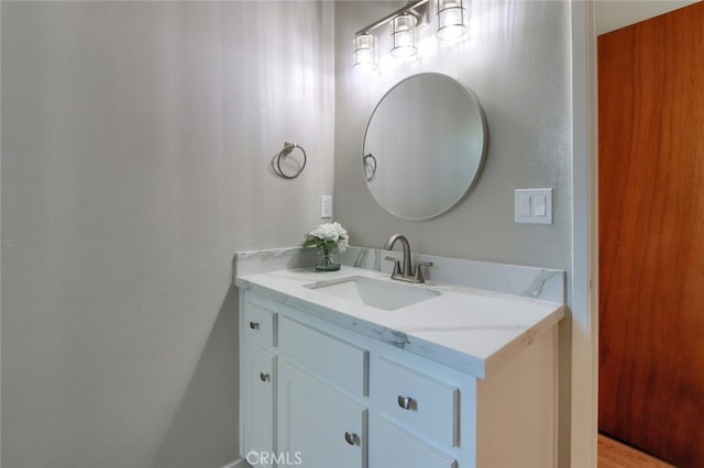 bathroom with hardwood / wood-style flooring and vanity