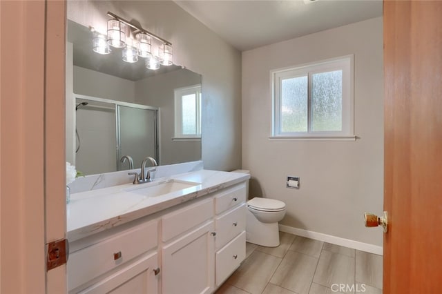 bathroom with vanity, toilet, and a shower with shower door