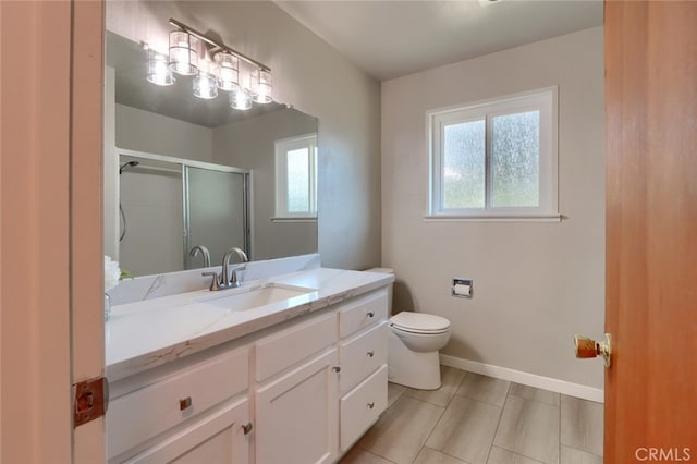 full bath with a shower stall, baseboards, toilet, and vanity