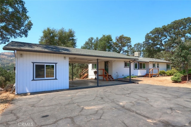 view of front facade featuring a carport and aphalt driveway