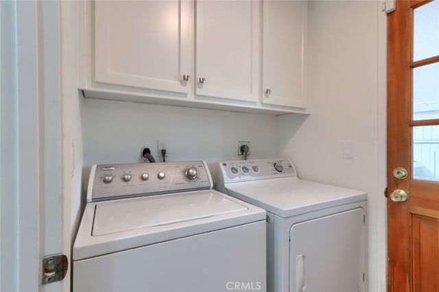 laundry area with cabinets and washing machine and clothes dryer