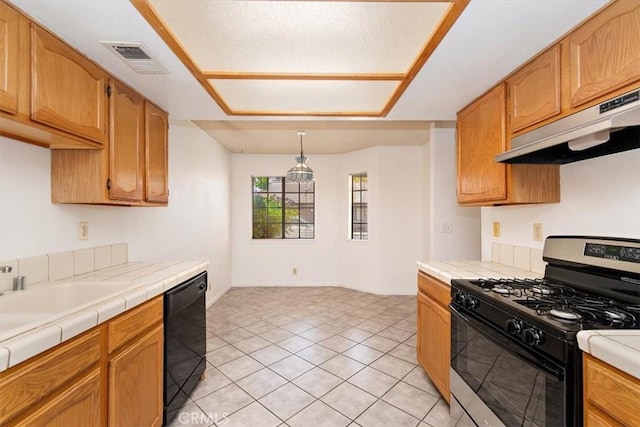 kitchen with stainless steel gas range, range hood, dishwasher, tile counters, and light tile patterned flooring