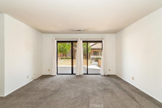 spare room with carpet floors and a textured ceiling