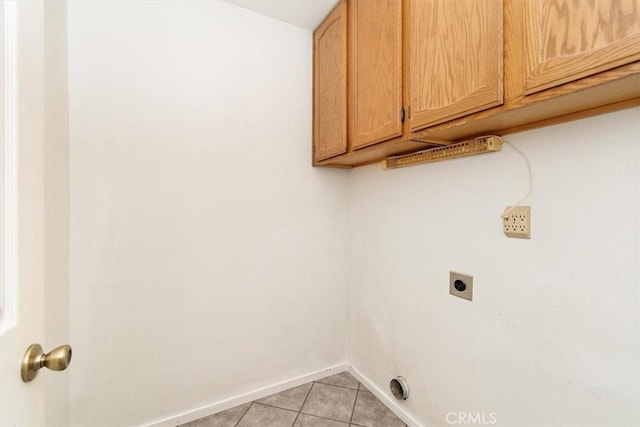 washroom featuring cabinets, light tile patterned floors, and electric dryer hookup