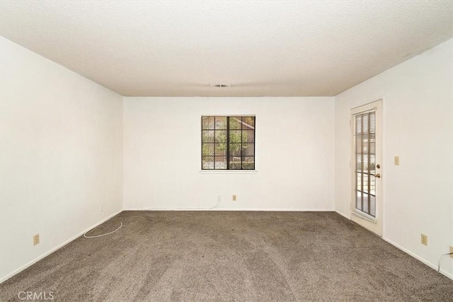 empty room featuring carpet floors and a textured ceiling