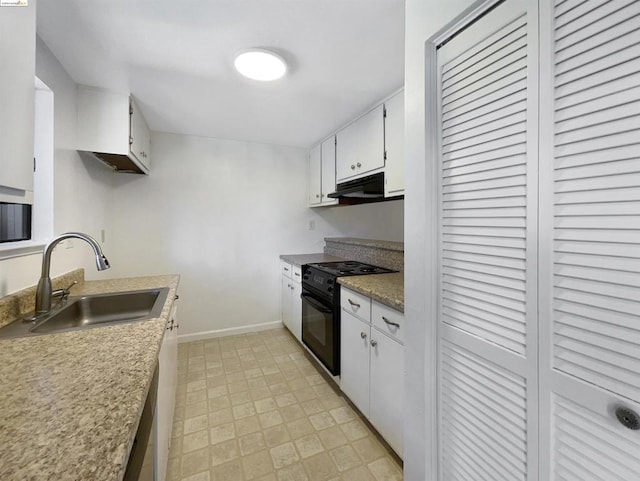 kitchen featuring black / electric stove, sink, and white cabinets