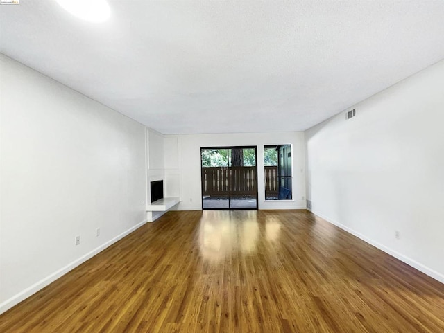 unfurnished living room featuring hardwood / wood-style flooring