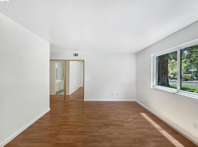 unfurnished room with dark hardwood / wood-style floors