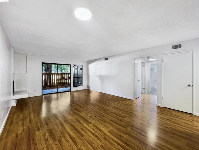 unfurnished living room with dark hardwood / wood-style floors