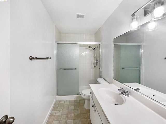 bathroom featuring vanity, toilet, and walk in shower