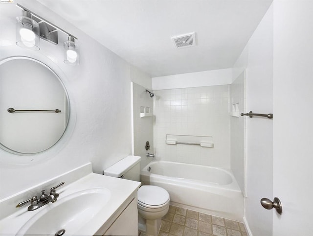 full bathroom with vanity, tiled shower / bath combo, and toilet