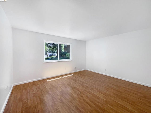 unfurnished room featuring hardwood / wood-style flooring