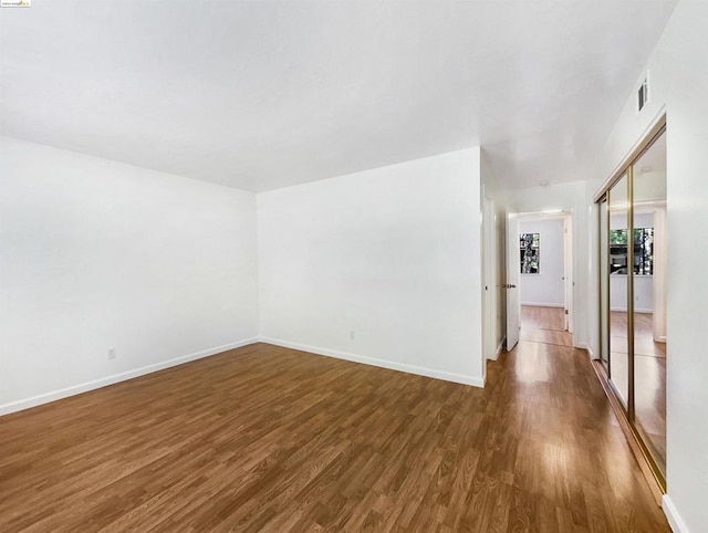 empty room with dark hardwood / wood-style floors