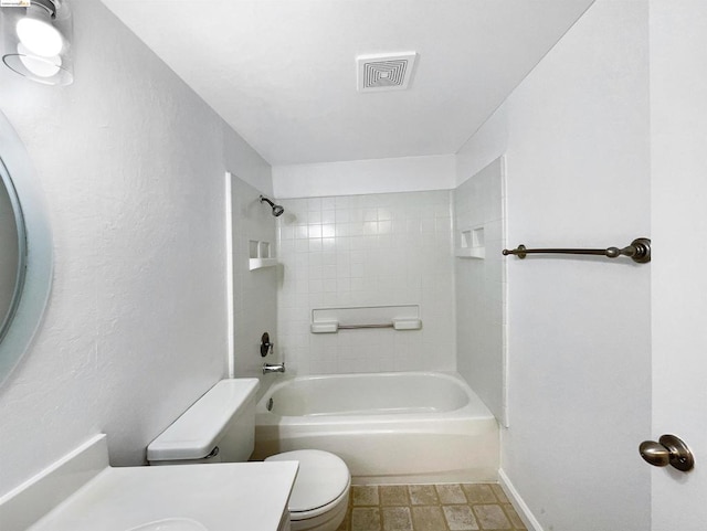 full bathroom featuring vanity, toilet, and tiled shower / bath