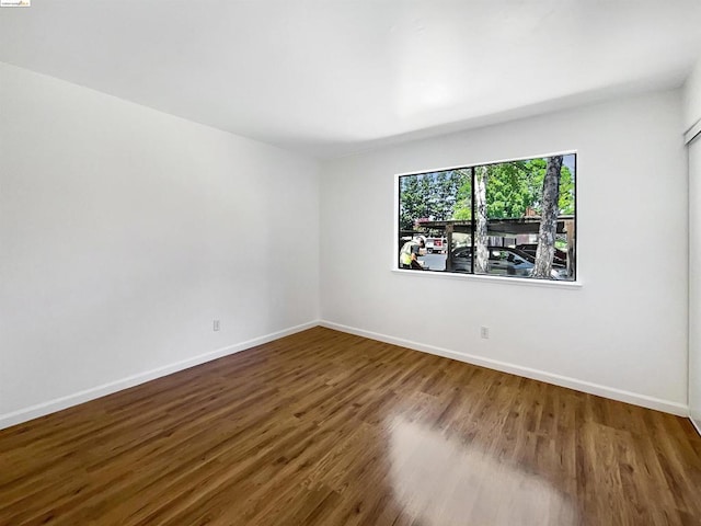 spare room with hardwood / wood-style flooring