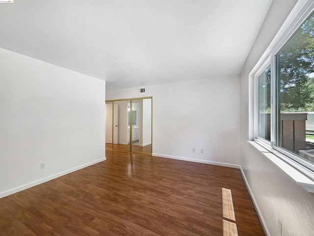 spare room with dark hardwood / wood-style flooring