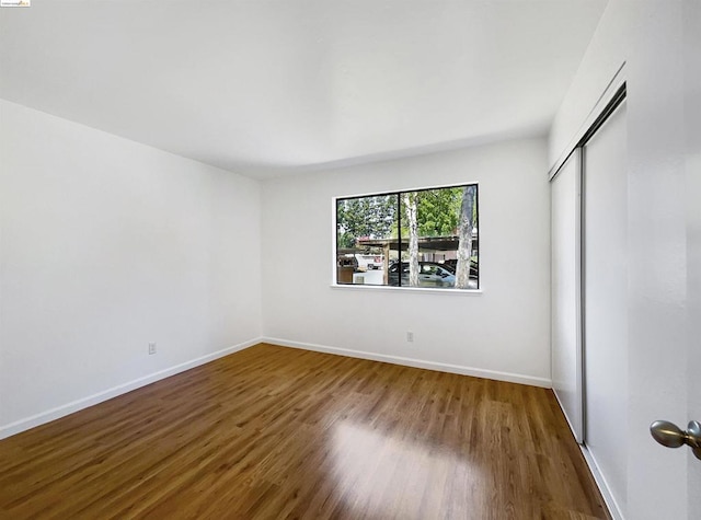 unfurnished bedroom featuring hardwood / wood-style floors and a closet