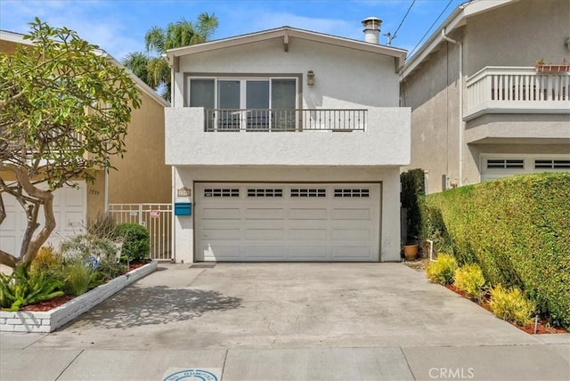 view of front of home featuring a garage and a balcony