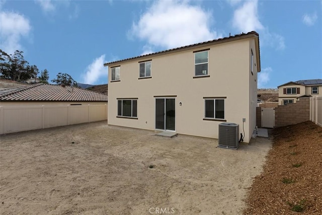 rear view of property with central AC unit