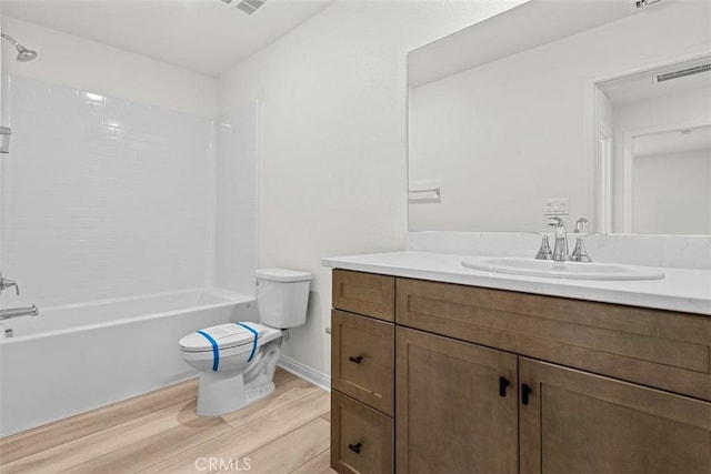 full bathroom with vanity, toilet, bathing tub / shower combination, and hardwood / wood-style floors