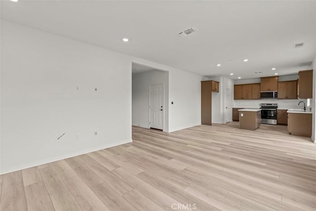 unfurnished living room with light hardwood / wood-style flooring