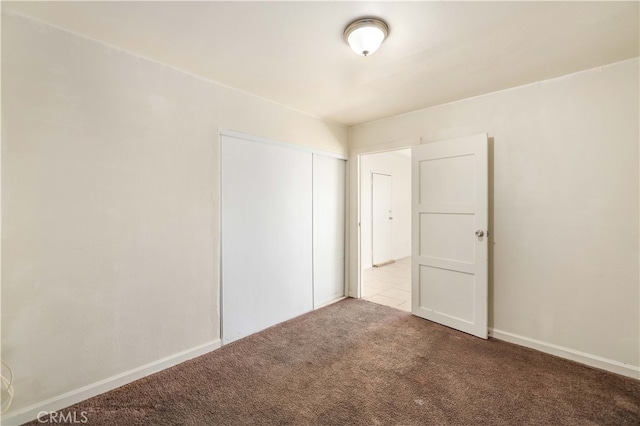 unfurnished room featuring light carpet