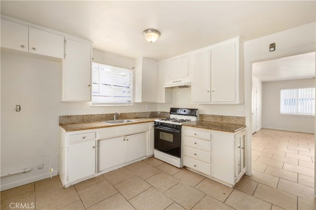 kitchen featuring white cabinets, white gas range oven, and sink