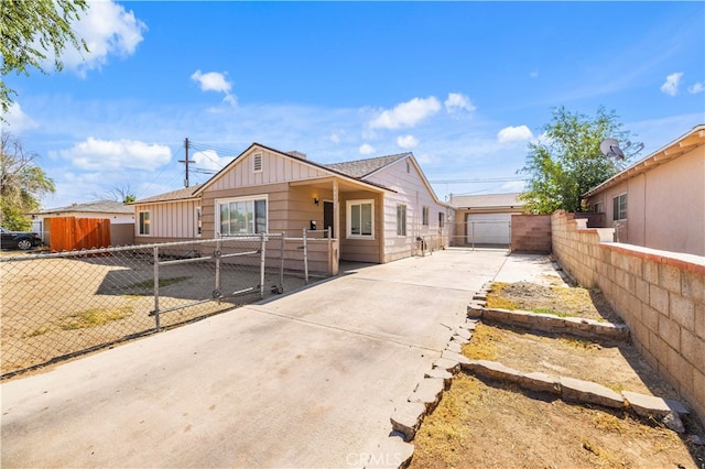 ranch-style home with a garage and an outbuilding