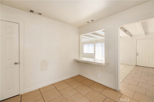 empty room with light tile patterned flooring