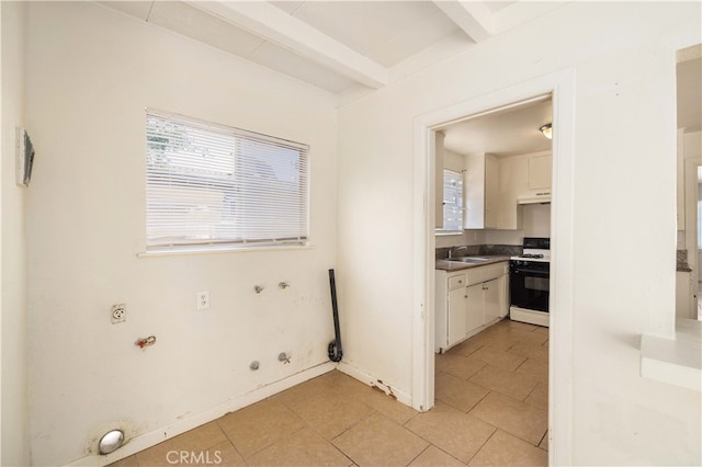 kitchen featuring white cabinets, sink, white range with gas cooktop, and a wealth of natural light