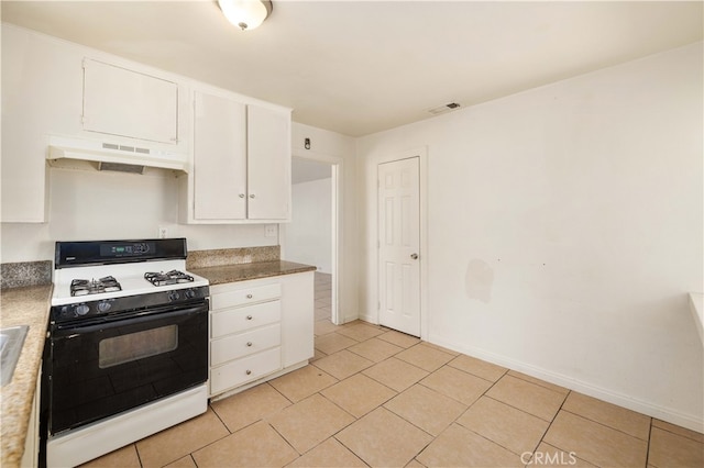 kitchen with light tile patterned flooring, white range with gas cooktop, and white cabinetry