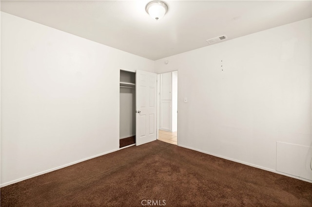 unfurnished bedroom featuring carpet floors and a closet