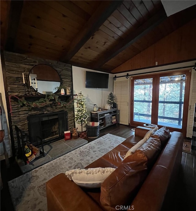 living room featuring lofted ceiling with beams, wood ceiling, hardwood / wood-style floors, and a stone fireplace