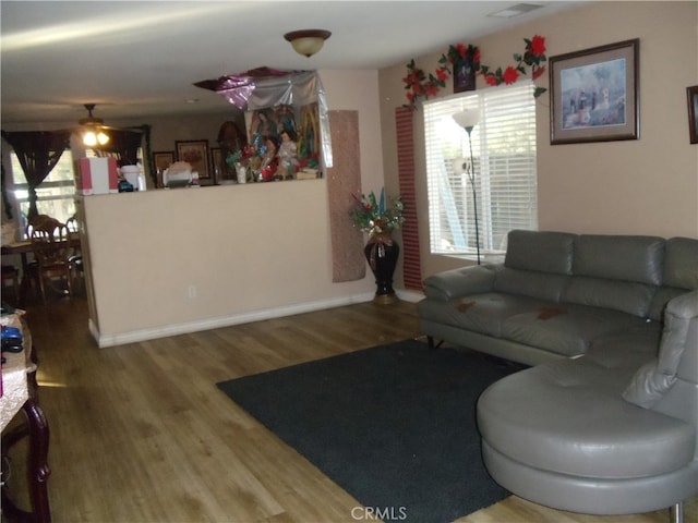 living room featuring hardwood / wood-style floors and ceiling fan