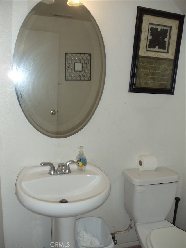 bathroom featuring sink and toilet