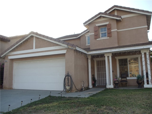 view of front of home with a front yard and a garage