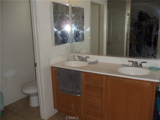 bathroom with vanity, toilet, and tile patterned floors