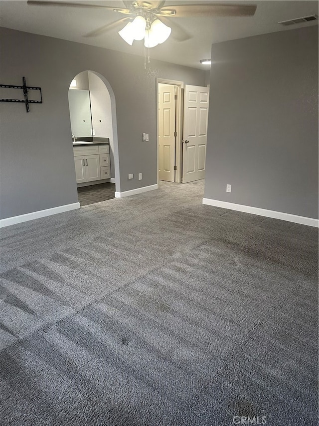 carpeted spare room featuring ceiling fan