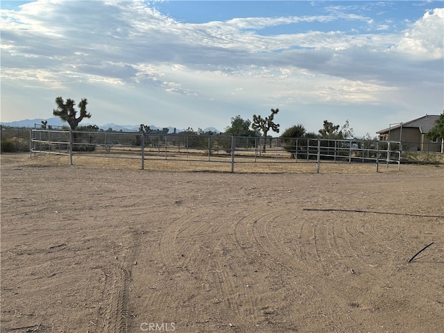 view of yard with a mountain view and a rural view