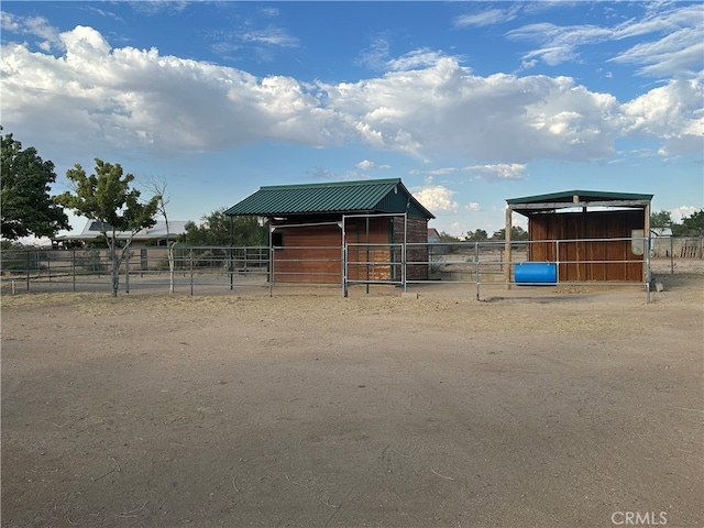 view of yard with a rural view and an outbuilding