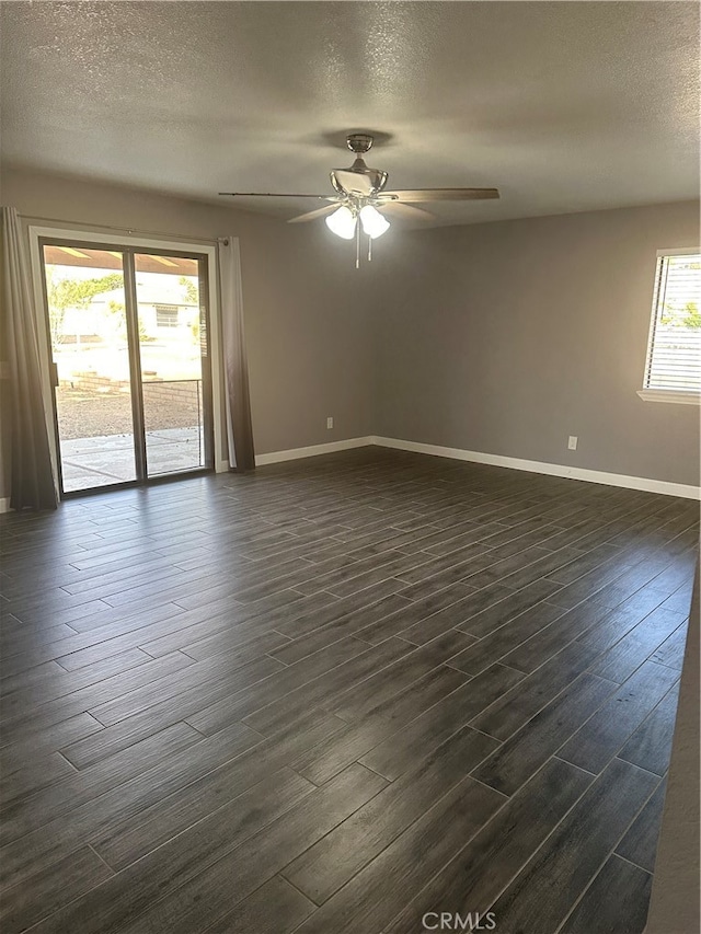 unfurnished room featuring a textured ceiling, dark hardwood / wood-style flooring, and ceiling fan