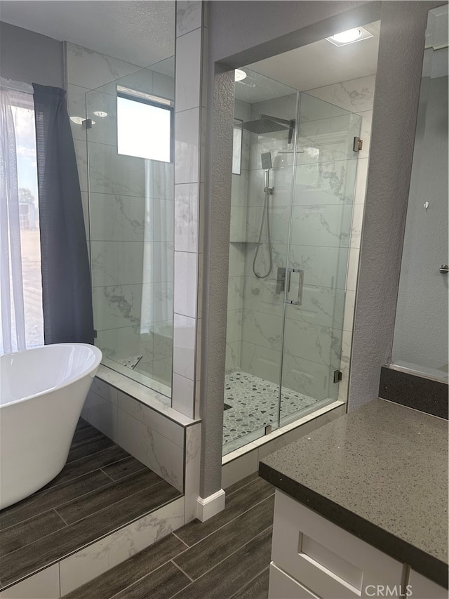 bathroom with vanity and plus walk in shower